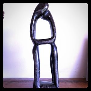 Stone figurines hugging/kissing